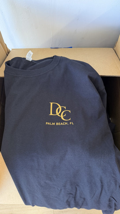 Same order, front: gold monogram on the left chest of a navy tee