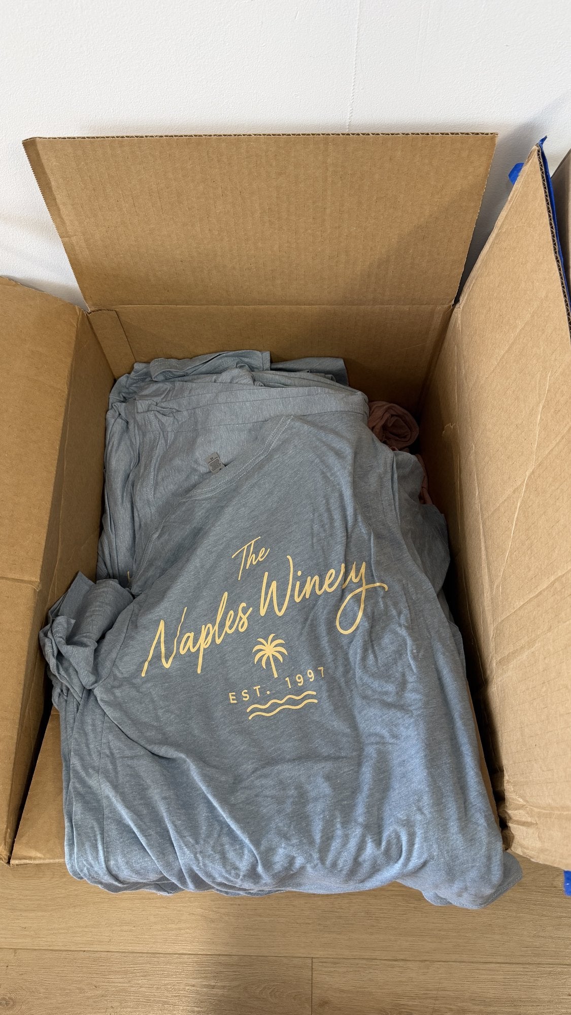 Real order: heather blue tees with a one-color gold script print for a local winery