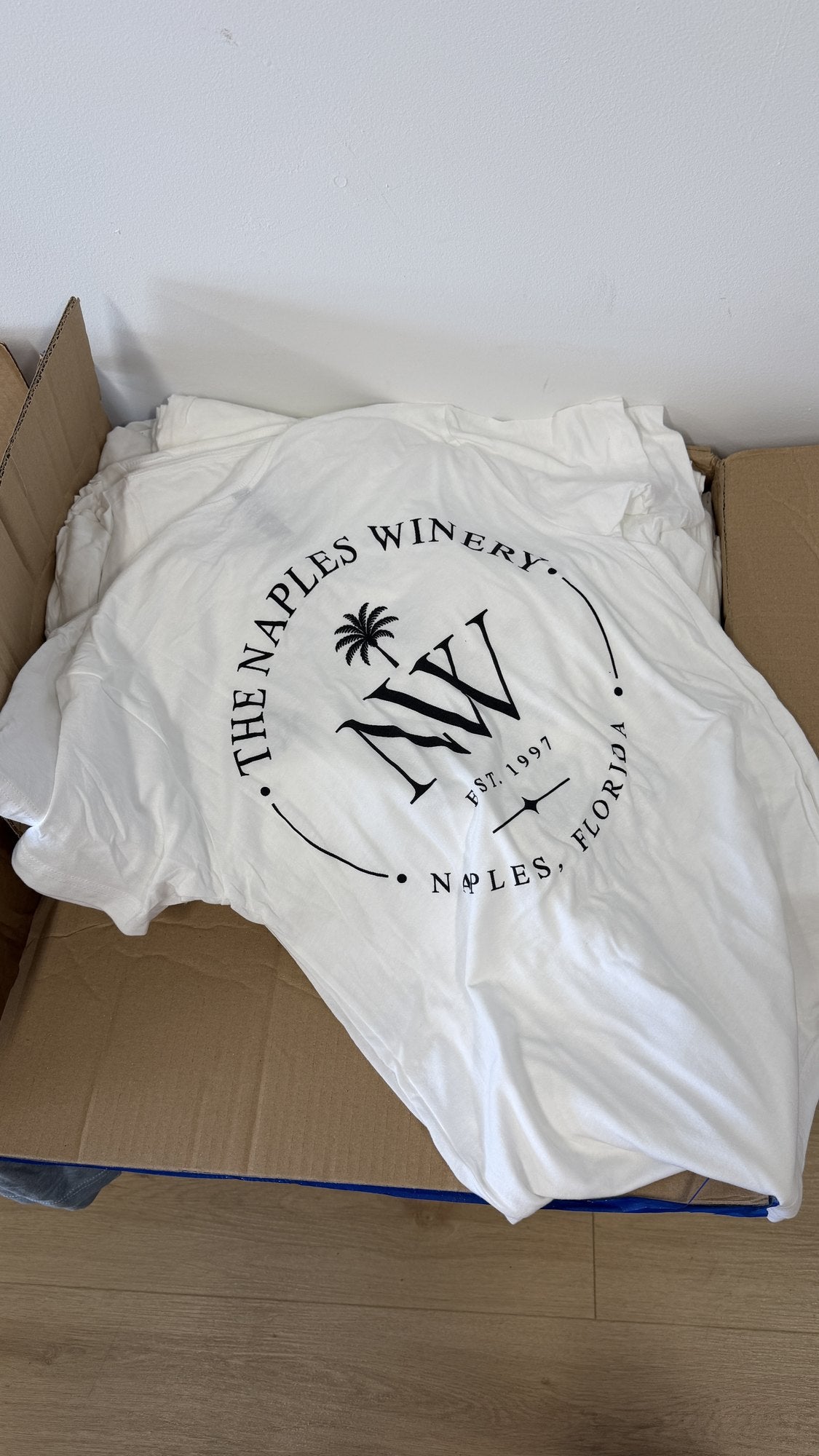 Real order, boxed at our Naples shop: white tees with a one-color screen print for a local winery