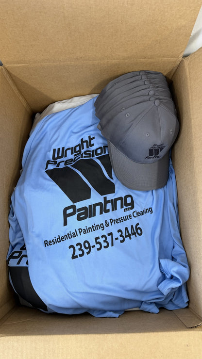 Real order, boxed at our Naples shop: light blue performance tees with a one-color print and embroidered gray caps for a painting and pressure washing crew