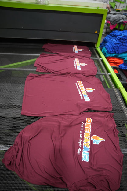 Real One Way Air order: maroon tees with the full-color logo coming off the dryer in our Charlotte shop