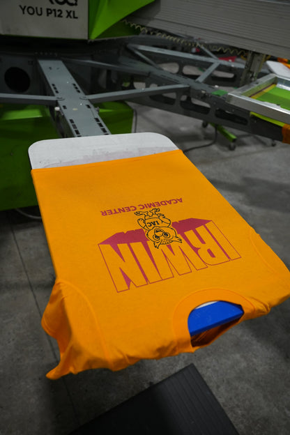 A tee on the automatic press mid-print in our Charlotte shop