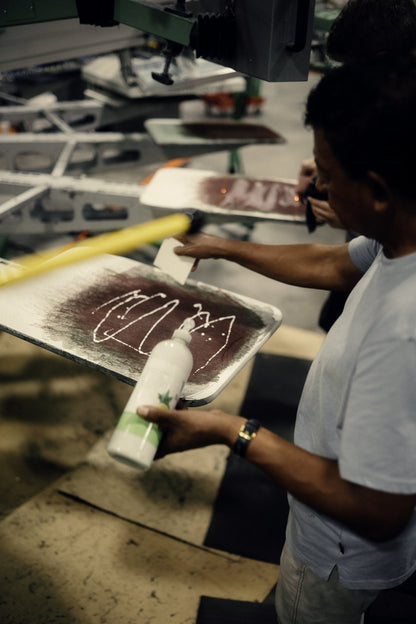 Our printer flooding a screen with ink before the print, real screen printing